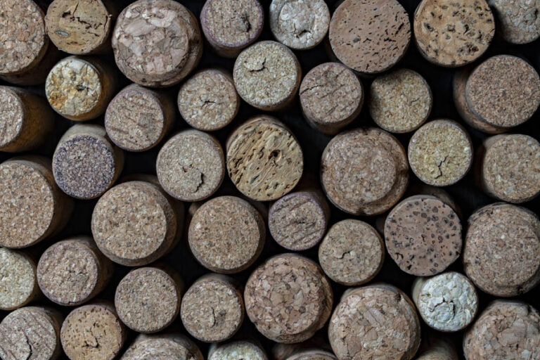 Lots of used wine corks as background, top view, closeup